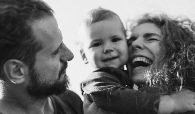 A happy family enjoying a heartfelt moment together in a black-and-white setting.